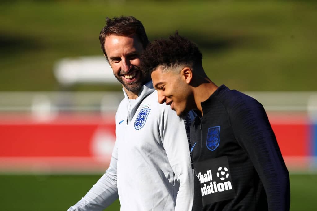 Gareth Southgate speaks to Jadon Sancho during an England Training Session at St Georges Park