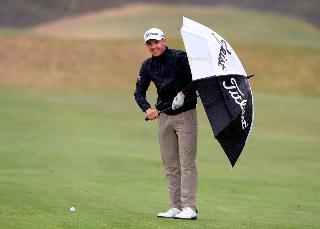 Grant Forrest of Scotland shelters from the wild weather during the third round of the joint EPGA and LPGA Vic Open golf tournament at the 13th Beach Golf Links at Barwon Heads near Melbourne on February 9, 2019. (Photo by WILLIAM WEST / AFP) / -- IMAGE RESTRICTED TO EDITORIAL USE - STRICTLY NO COMMERCIAL USE -- (Photo credit should read WILLIAM WEST/AFP/Getty Images)