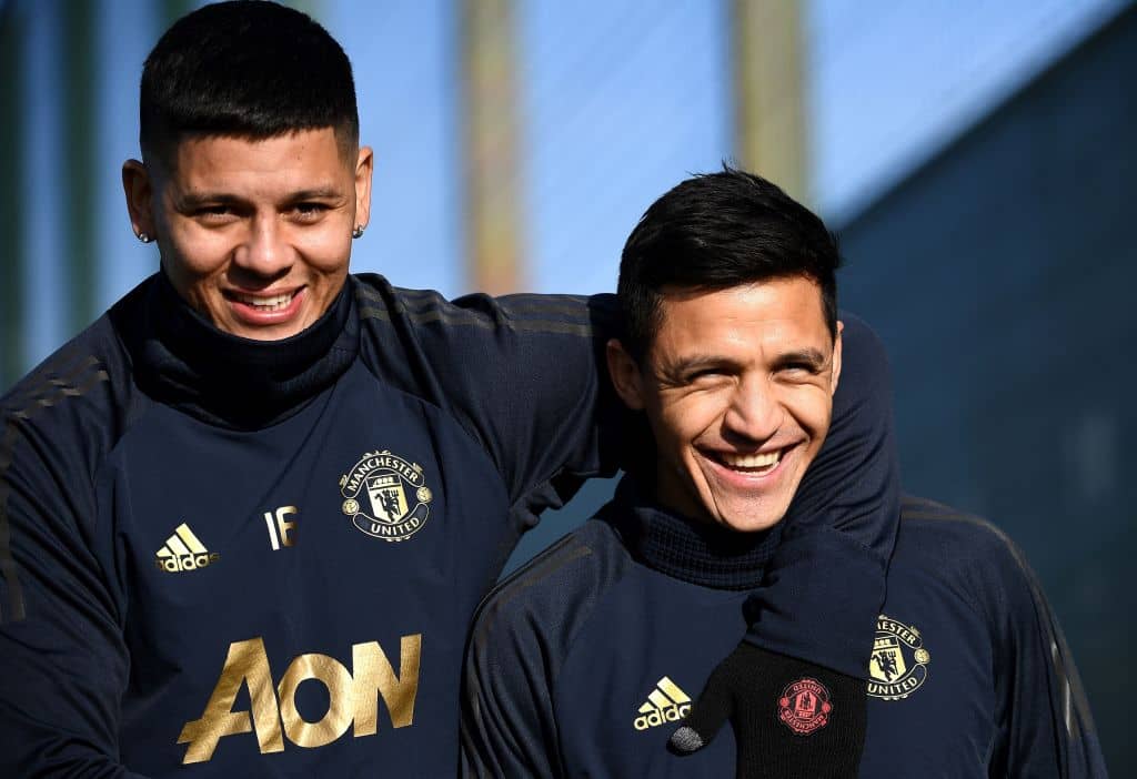 Manchester United's Argentinian defender Marcos Rojo and Manchester United's Chilean forward Alexis Sanchez arrive for a training session at the Carrington Training complex in Manchester, north west England on February 11, 2019, on the eve the first leg of their UEFA Champions League football match against Paris Saint-Germain. (Photo by FRANCK FIFE / AFP) (Photo credit should read FRANCK FIFE/AFP/Getty Images)