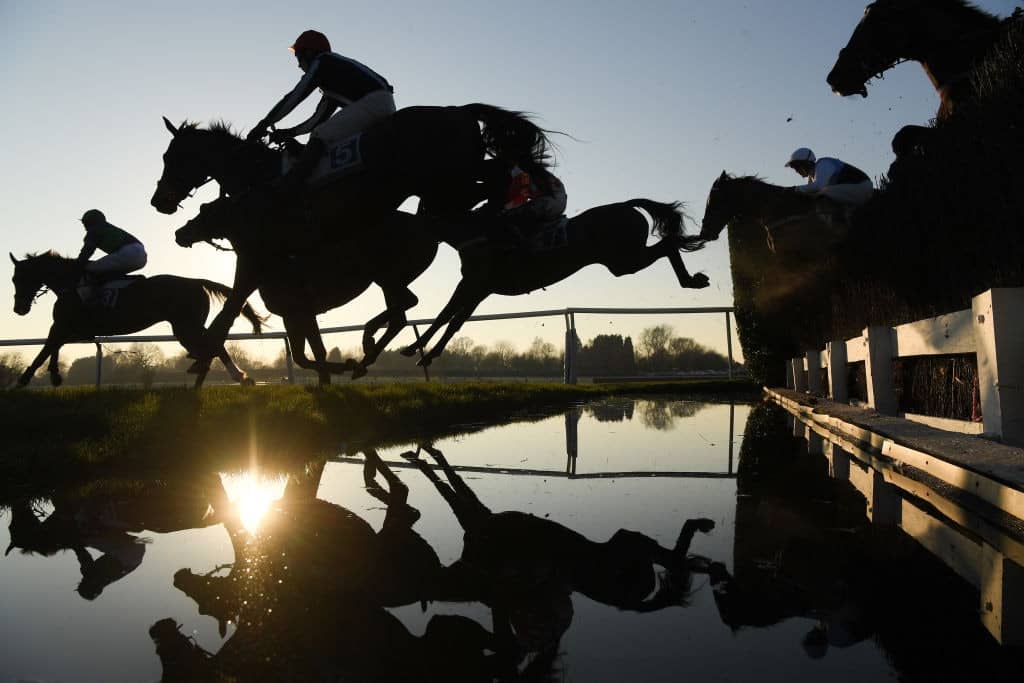 LEICESTER, ENGLAND - FEBRUARY 26: Runners and riders clear the water jump in the Cottesmore "Grassroots" Maiden Hunter's Steeple Chase at Leicester racecourse on February 26, 2019 in Leicester, England. (Photo by Mike Hewitt/Getty Images)