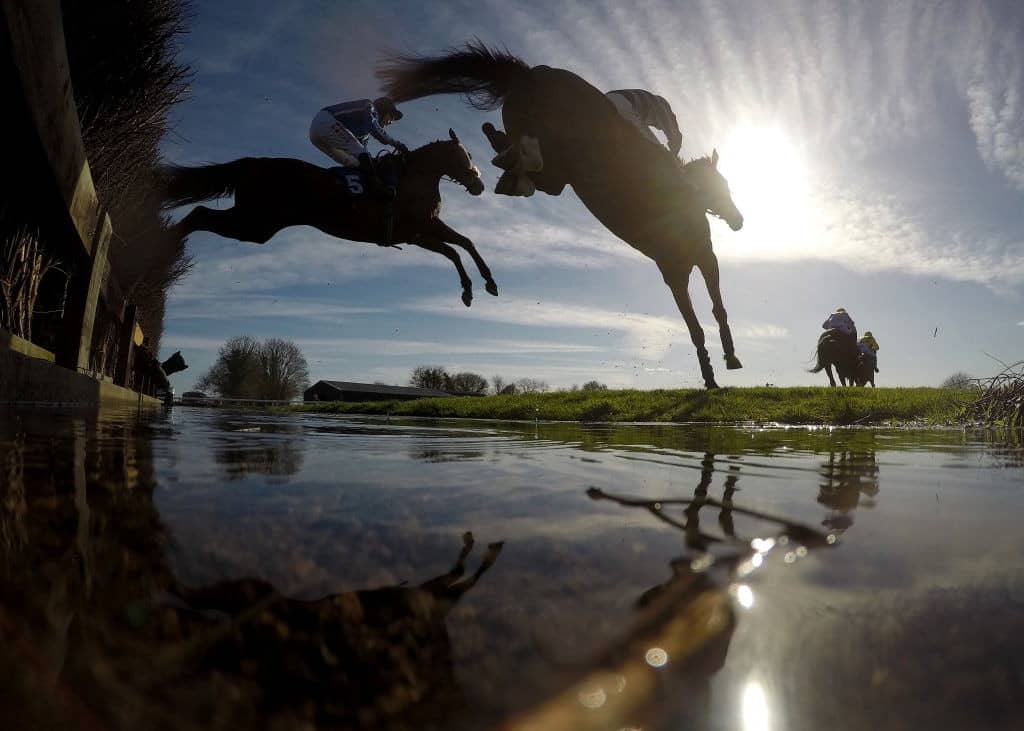 WINCANTON, ENGLAND - MARCH 25: Runners clear the water jump during the racingtv.com Novices' Steeple Chase at Wincanton Racecourse on March 25, 2019 in Wincanton, England. (Photo by Dan Mullan/Getty Images)