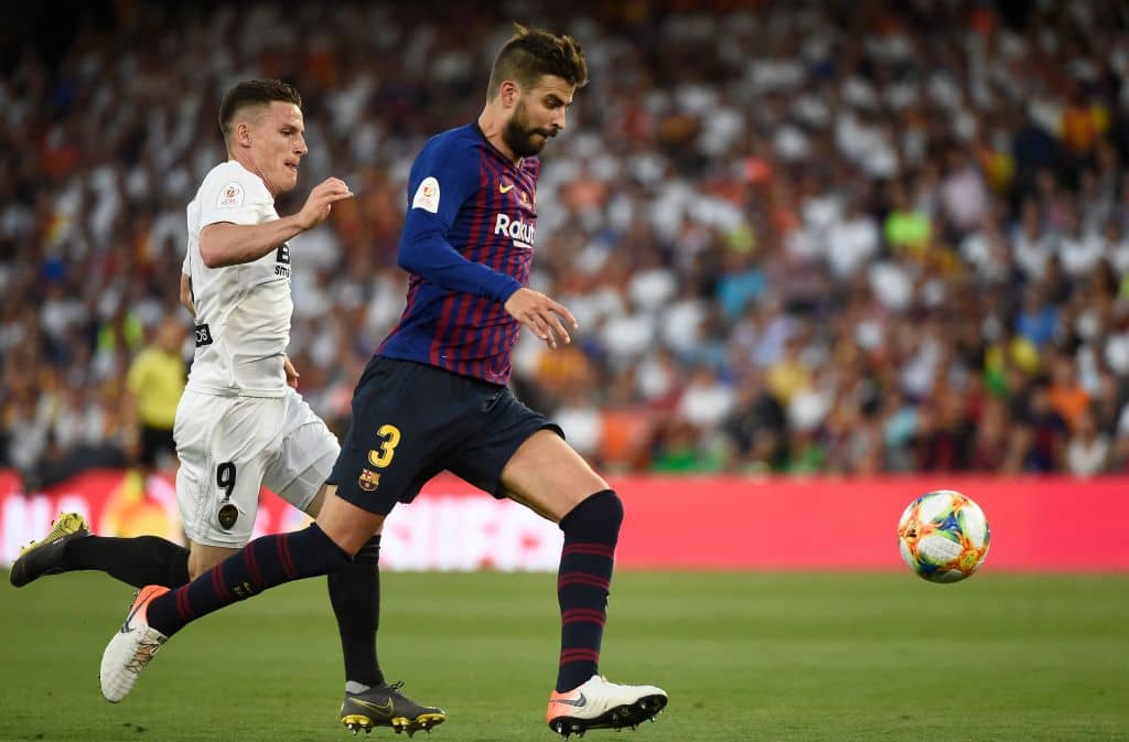 Barcelona's Spanish defender Gerard Pique (R) vies with Valencia's French forward Kevin Gameiro during the 2019 Spanish Copa del Rey (King's Cup) final football match between Barcelona and Valencia on May 25, 2019 at the Benito Villamarin stadium in Sevilla. (Photo by JOSE JORDAN / AFP) (Photo credit should read JOSE JORDAN/AFP/Getty Images)