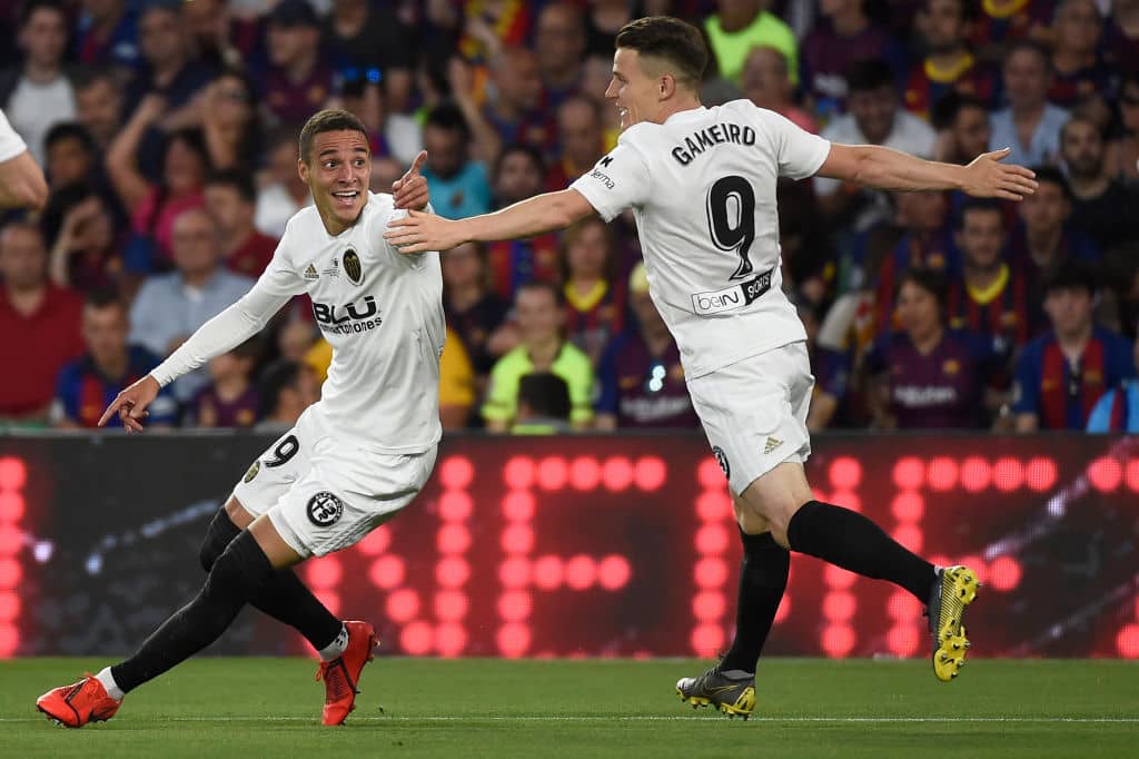 Valencia's Spanish forward Rodrigo Moreno (L) celebrates after scoring his team's second goal during the 2019 Spanish Copa del Rey (King's Cup) final football match between Barcelona and Valencia on May 25, 2019 at the Benito Villamarin stadium in Sevilla. (Photo by JOSE JORDAN / AFP) (Photo credit should read JOSE JORDAN/AFP/Getty Images)