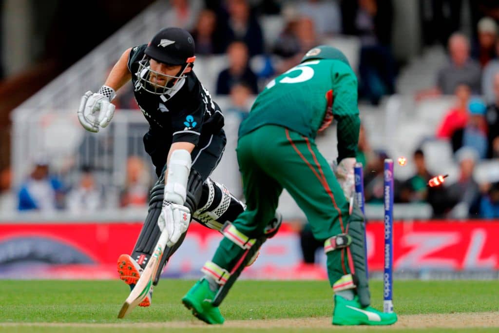 TOPSHOT - Bangladesh's Mushfiqur Rahim (R) knocks the bails off before gathering the ball meaning New Zealand's captain Kane Williamson (L) avoids being run out during the 2019 Cricket World Cup group stage match between Bangladesh and New Zealand at The Oval in London on June 5, 2019. (Photo by Adrian DENNIS / AFP) / RESTRICTED TO EDITORIAL USE (Photo credit should read ADRIAN DENNIS/AFP/Getty Images)