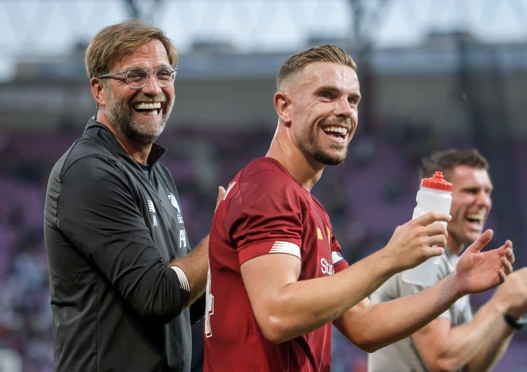 Liverpool's German head coach Jurgen Klopp (L) and Liverpool's British midfielder Jordan Henderson (R) celebrate at the end of the International friendly football match between Liverpool and Lyon on July 31, 2019 in Geneva. (Photo by FABRICE COFFRINI / AFP) (Photo credit should read FABRICE COFFRINI/AFP/Getty Images) Harry's Picks Week Four
