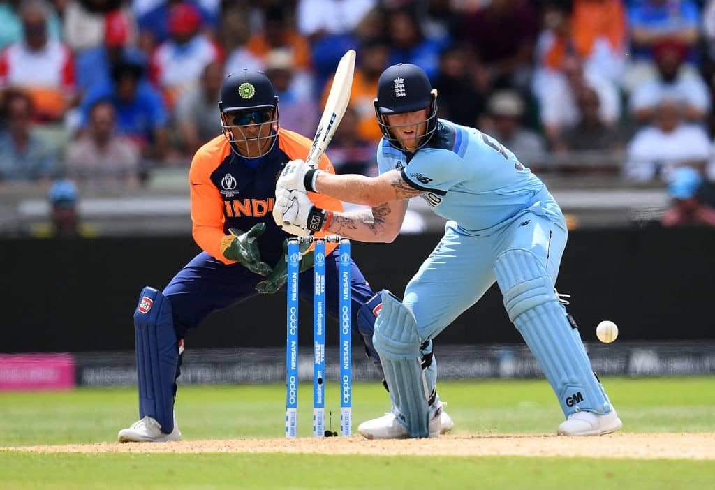 BIRMINGHAM, ENGLAND - JUNE 30: Ben Stokes of England plays a reverse sweep as MS Dhoni of India looks on during the Group Stage match of the ICC Cricket World Cup 2019 between England and India at Edgbaston on June 30, 2019 in Birmingham, England. (Photo by Clive Mason/Getty Images)