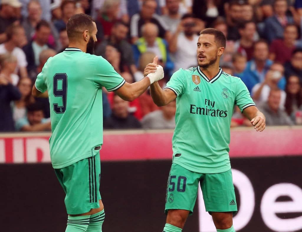 Real Madrid's forward Eden Hazard celebrates scoring with his team-mate Real Madrid's French forward Karim Benzema (L) during the pre-Season friendly football match FC Red Bull Salzburg v Real Madrid in Salzburg, Austria on August 7, 2019. (Photo by KRUGFOTO / APA / AFP) / Austria OUT (Photo credit should read KRUGFOTO/AFP/Getty Images)