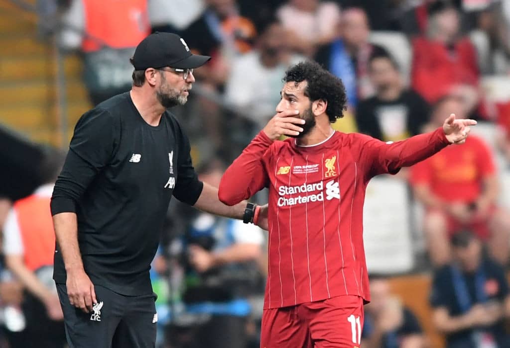 Liverpool's Egyptian midfielder Mohamed Salah speaks with Liverpool's German manager Jurgen Klopp (L) during the UEFA Super Cup 2019 football match between FC Liverpool and FC Chelsea at Besiktas Park Stadium in Istanbul on August 14, 2019. (Photo by OZAN KOSE / AFP) (Photo credit should read OZAN KOSE/AFP/Getty Images)