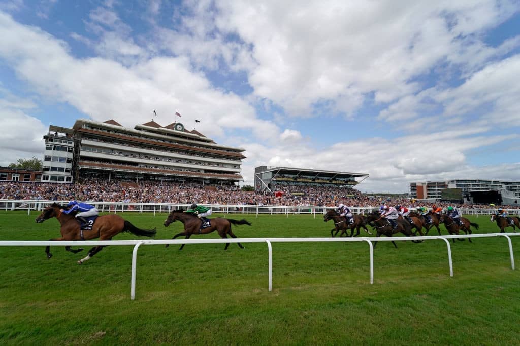 NEWBURY, ENGLAND - JULY 20: Jason Watson riding Withhold (L) win The Marsh Cup Handicap at Newbury Racecourse on July 20, 2019 in Newbury, England. (Photo by Alan Crowhurst/Getty Images)