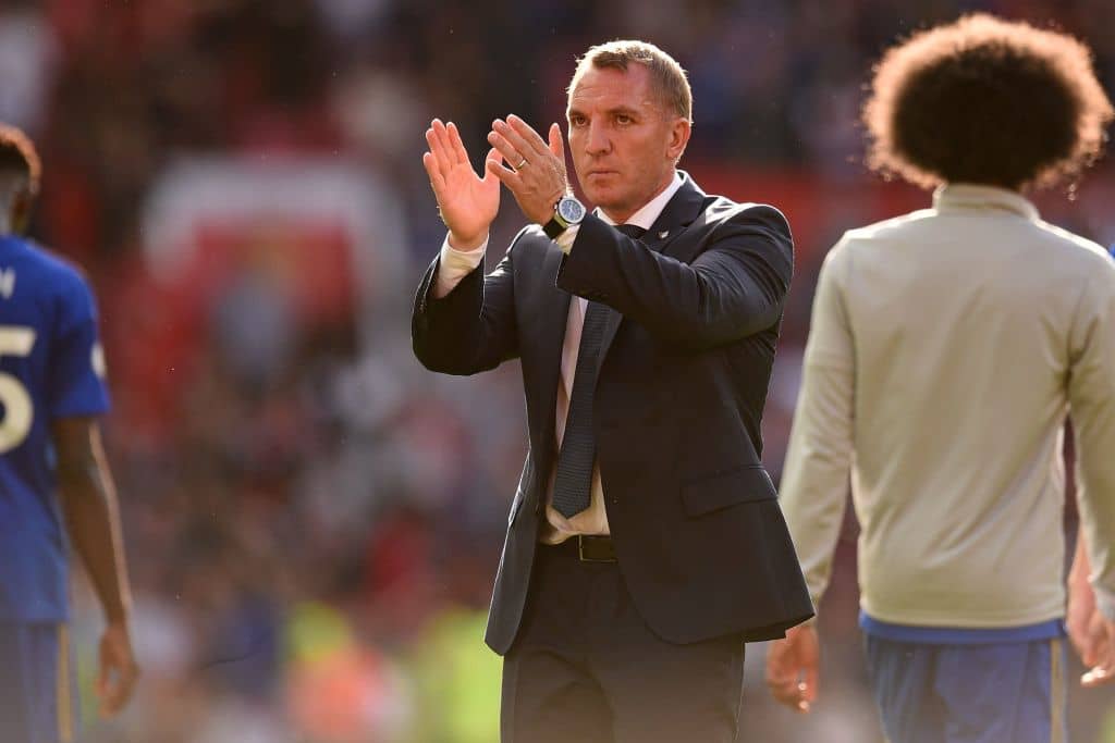 Leicester City's Northern Irish manager Brendan Rodgers (C) applauds on the pitch after the English Premier League football match between Manchester United and Leicester City at Old Trafford in Manchester, north west England, on September 14, 2019. - Manchester United won the game 1-0. (Photo by Oli SCARFF / AFP) / RESTRICTED TO EDITORIAL USE. No use with unauthorized audio, video, data, fixture lists, club/league logos or 'live' services. Online in-match use limited to 120 images. An additional 40 images may be used in extra time. No video emulation. Social media in-match use limited to 120 images. An additional 40 images may be used in extra time. No use in betting publications, games or single club/league/player publications. / (Photo credit should read OLI SCARFF/AFP/Getty Images)