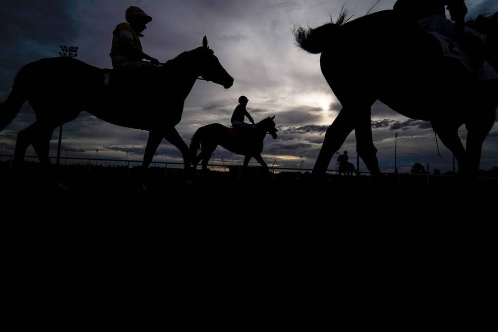SUNBURY, ENGLAND - AUGUST 28: A general view as runners make their way to the start at Kempton Park Racecourse on August 28, 2019 in Sunbury, England. (Photo by Alan Crowhurst/Getty Images)