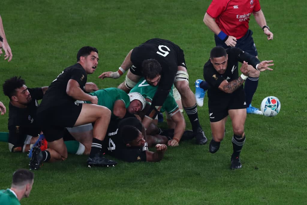 New Zealand's scrum-half Aaron Smith ()R passes the ball during the Japan 2019 Rugby World Cup quarter-final match between New Zealand and Ireland at the Tokyo Stadium in Tokyo on October 19, 2019. (Photo by Behrouz MEHRI / AFP) (Photo by BEHROUZ MEHRI/AFP via Getty Images)