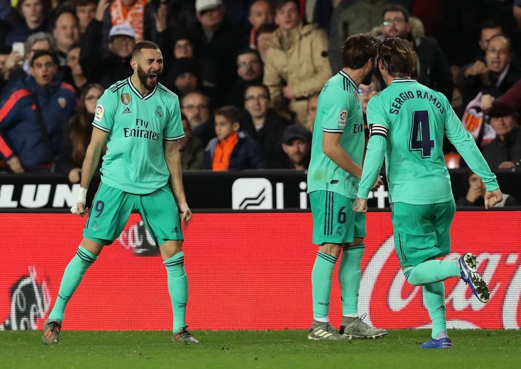 VALENCIA, SPAIN - DECEMBER 15: Karim Benzema (L) of Real Madrid celebrates after scoring the equaliser goal during the Liga match between Valencia CF and Real Madrid CF at Estadio Mestalla on December 15, 2019 in Valencia, Spain. (Photo by Angel Martinez/Getty Images)