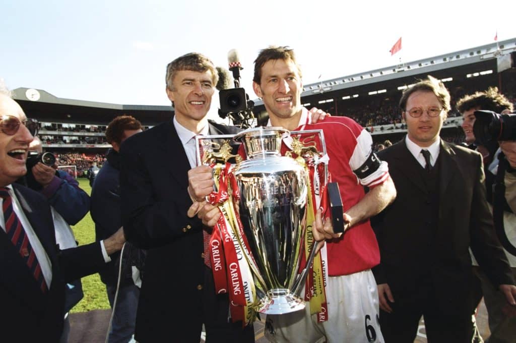 Arsenal manager Arsene Wenger and club captain Tony Adams hold the championship trophy 