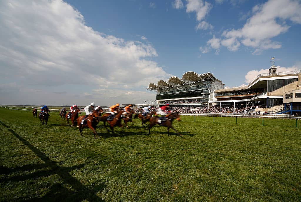 NEWMARKET, ENGLAND - APRIL 14: A general view as runners pass the grandstand and finish at Newmarket racecourse on April 14, 2016 in Newmarket, England. (Photo by Alan Crowhurst/Getty Images)