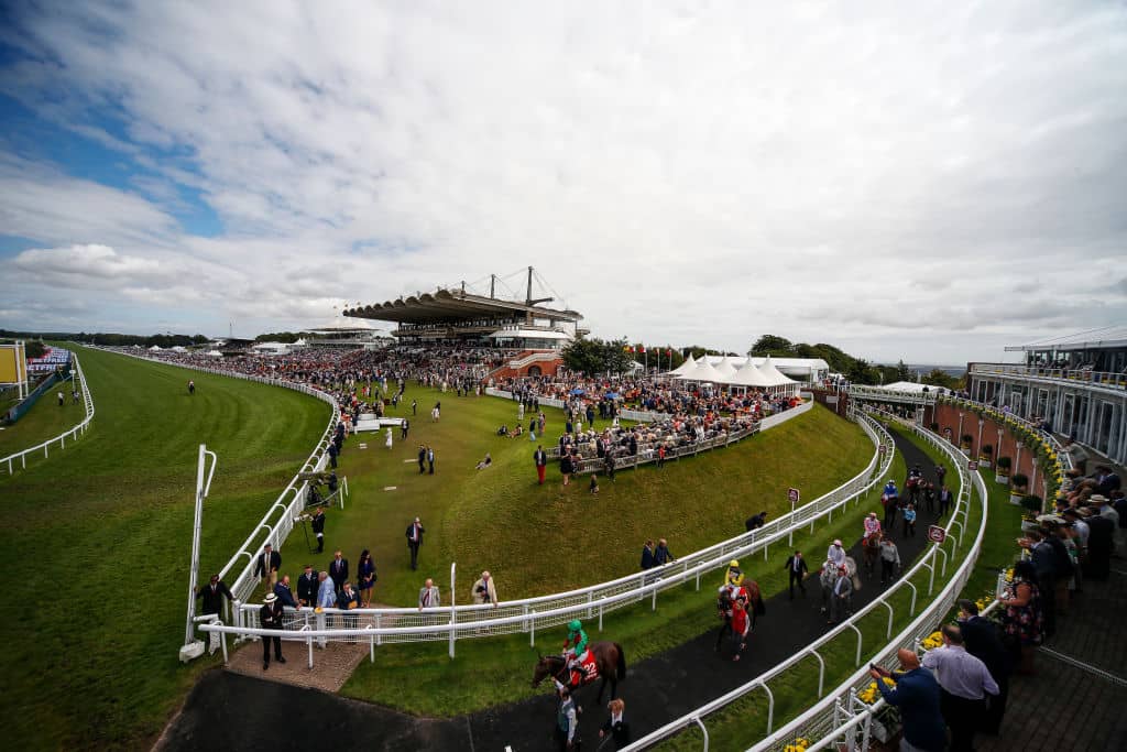 CHICHESTER, ENGLAND - AUGUST 04: A general view as runners make their way onto the track for The Betfred Mile Handicap Stakes on day four of the Qatar Goodwood Festival at Goodwood racecourse on August 4, 2017 in Chichester, England. (Photo by Alan Crowhurst/Getty Images)