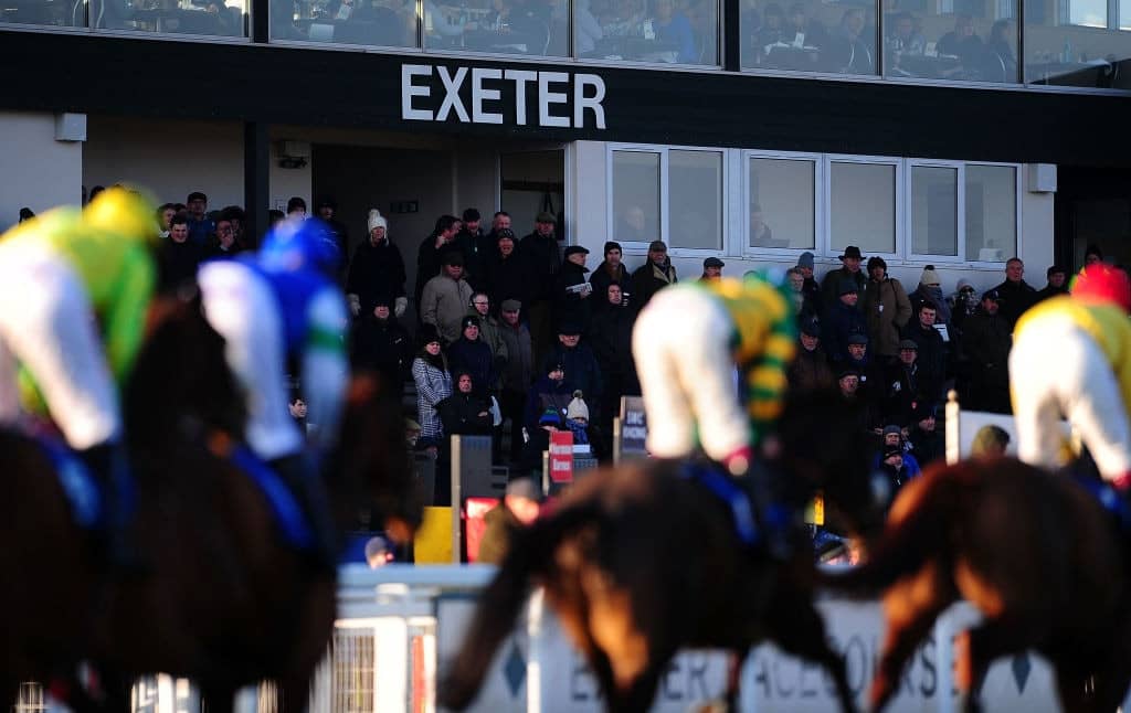 EXETER, ENGLAND - FEBRUARY 23: Runners make their way past the grandstand at Exeter Racecourse on February 23, 2018 in Exeter, England. (Photo by Harry Trump/Getty Images)