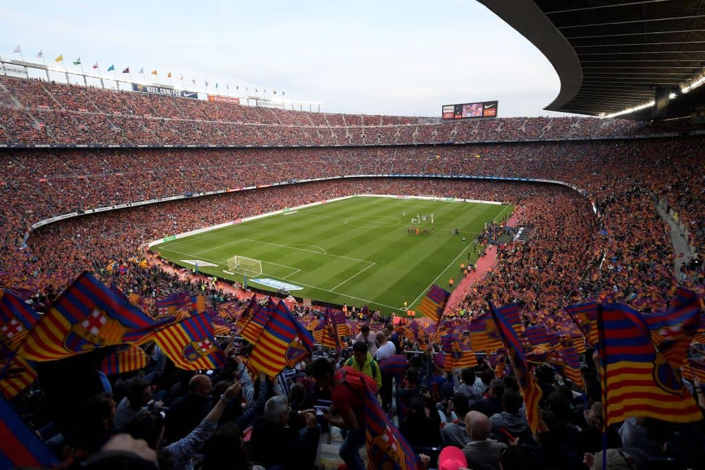 TOPSHOT - Fans cheer before the Spanish league football match between FC Barcelona and Real Sociedad at the Camp Nou stadium in Barcelona on May 20, 2018. (Photo by LLUIS GENE / AFP) (Photo credit should read LLUIS GENE/AFP/Getty Images)