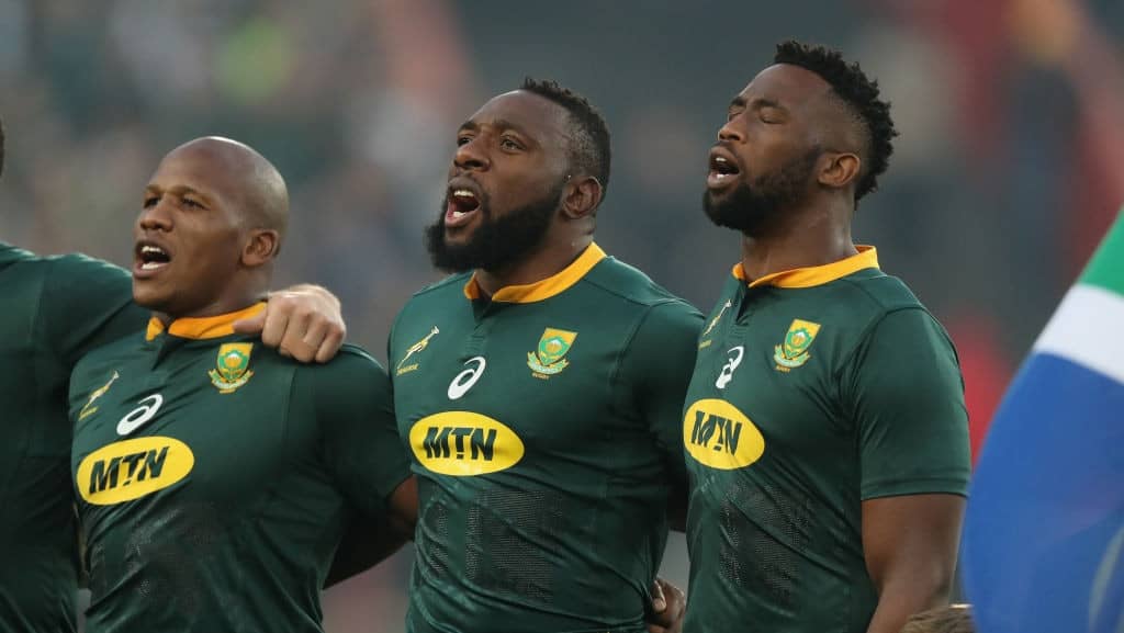 JOHANNESBURG, SOUTH AFRICA - JUNE 09: Siya Kolisi, (R) the first non white South Africa Springbok captain sings the national anthem with team mates Tendai Mtawarira and Bongi Mbonambi (L) during the first test match between South Africa and England at Elllis Park on June 9, 2018 in Johannesburg, South Africa. (Photo by David Rogers/Getty Images)