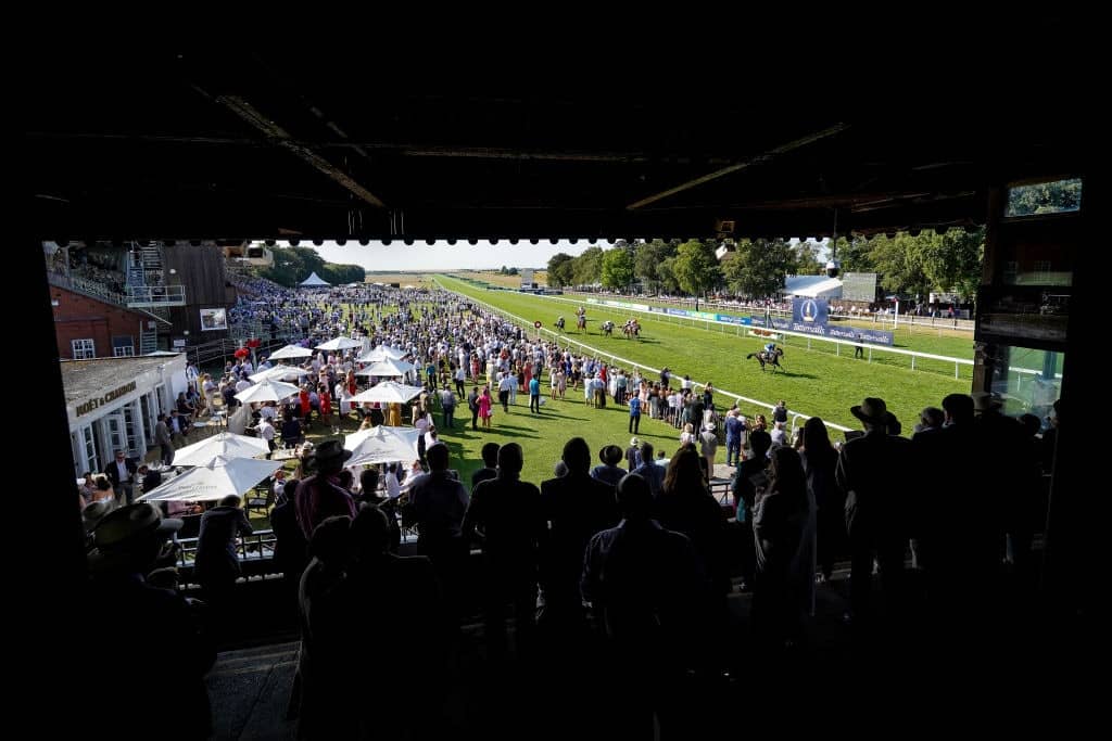 NEWMARKET, ENGLAND - JULY 13: A general view as runners pass the winning post at Newmarket Racecourse on July 13, 2018 in Newmarket, United Kingdom. (Photo by Alan Crowhurst/Getty Images)